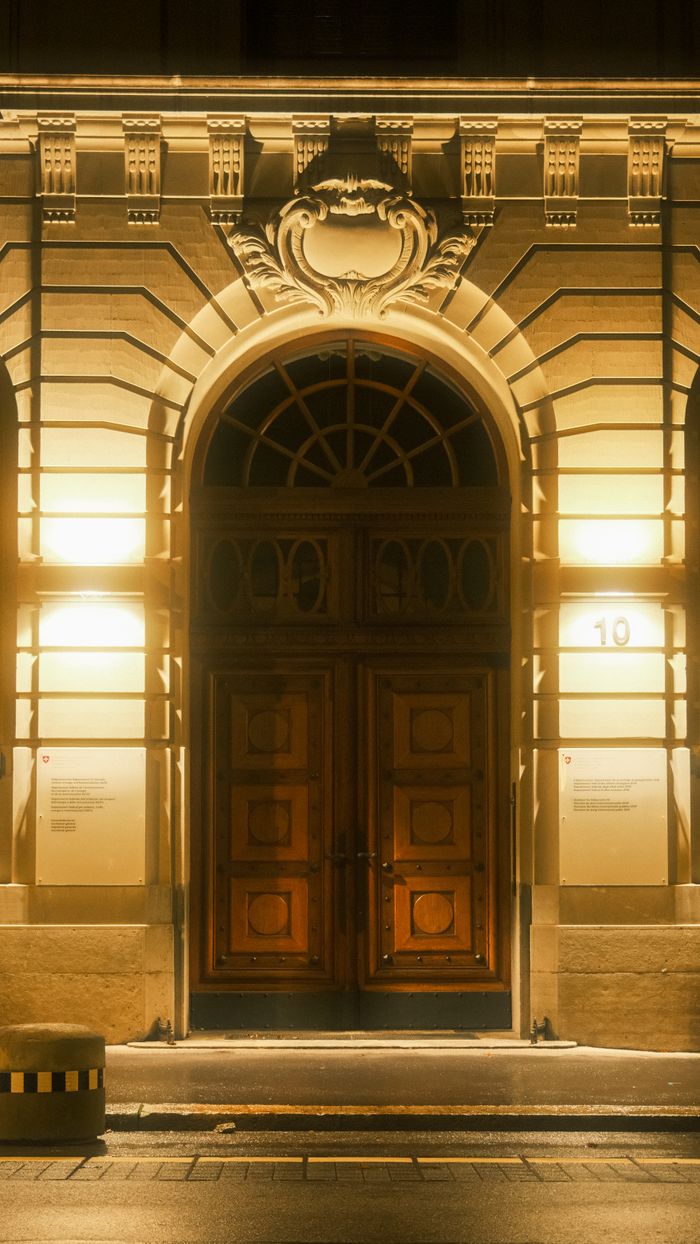 Mastering the First Impression: Your intriguing post title goes here Illuminated historic building entrance with classic archway at night.